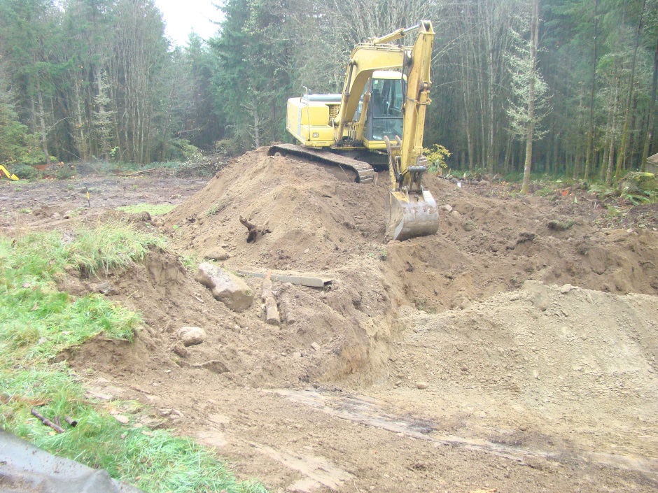 Excavator making mound