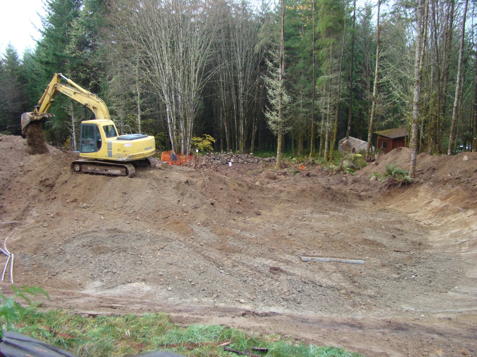 Excavator on mound dumping