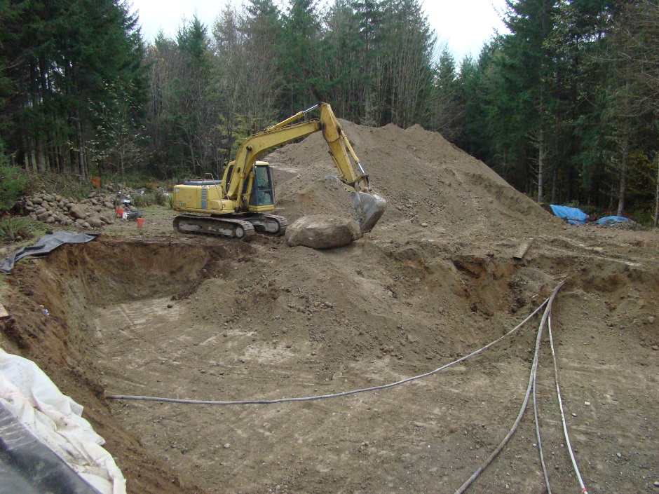 Excavator moving rock