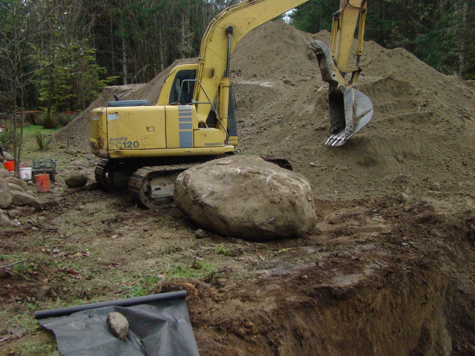 Excavator moving rock