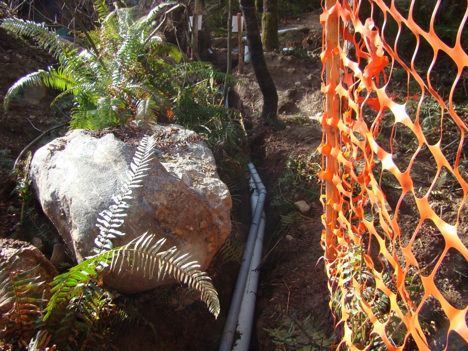 Drainage ditch route past rock