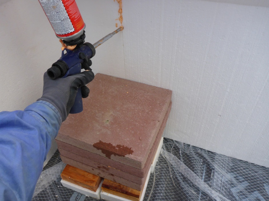 Foam Gun Pressed Into Crack Paving Slab Holding